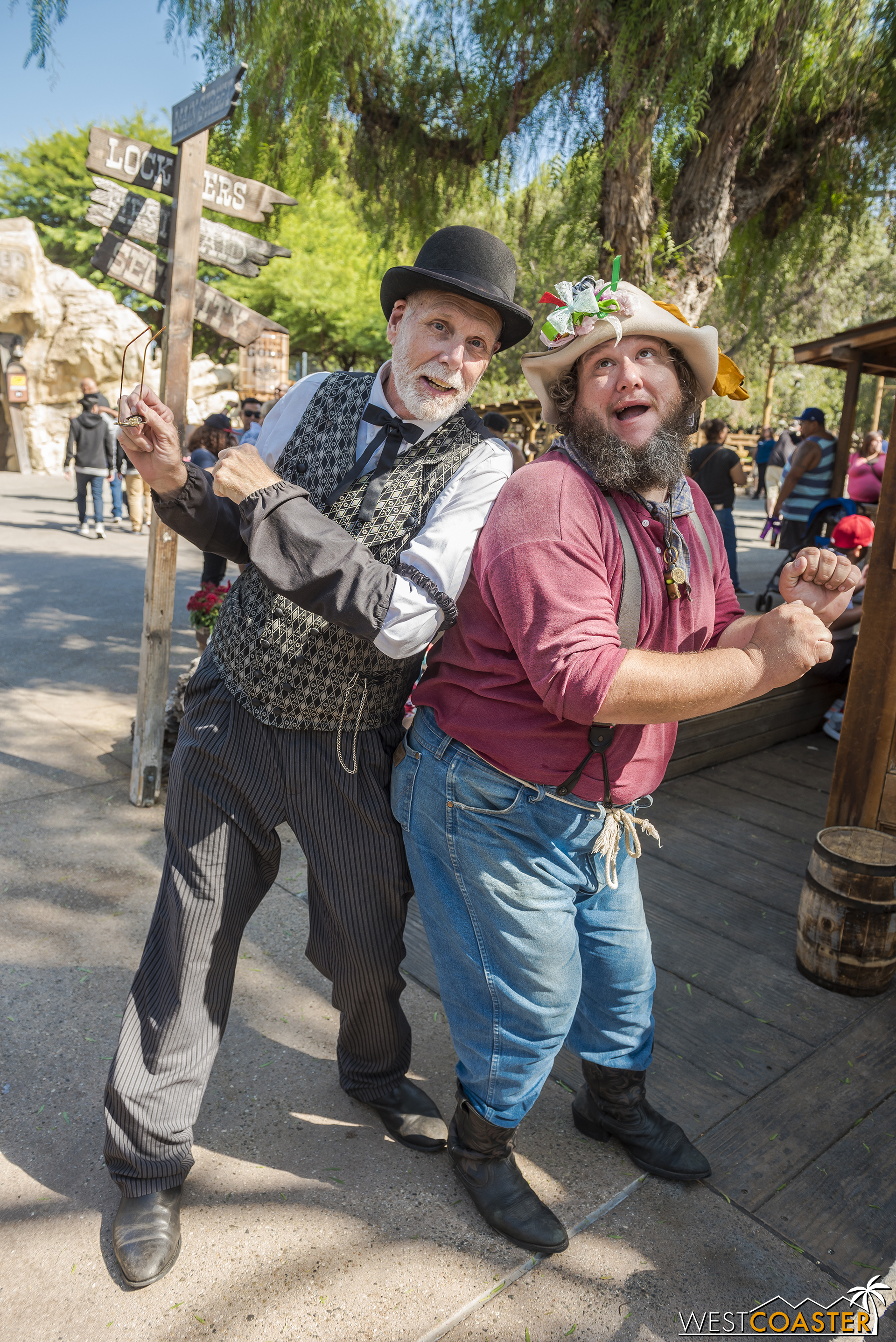  Zeke Connelly (left) and Prospector Flint Stahlek share a silly moment outside of the Assayer’s Office.  But Zeke worries about the delayed stagecoach, which is carrying his beloved wife to back to town. 