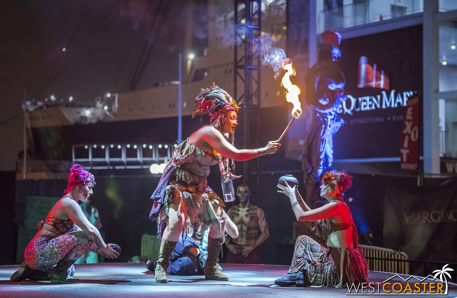  The Voodoo Priestess bequeaths fire to various performers. 