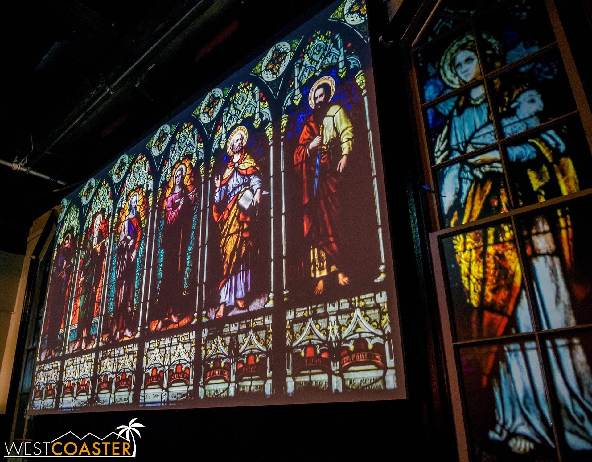 The stained glass becomes the cinema screen once the attraction begins.