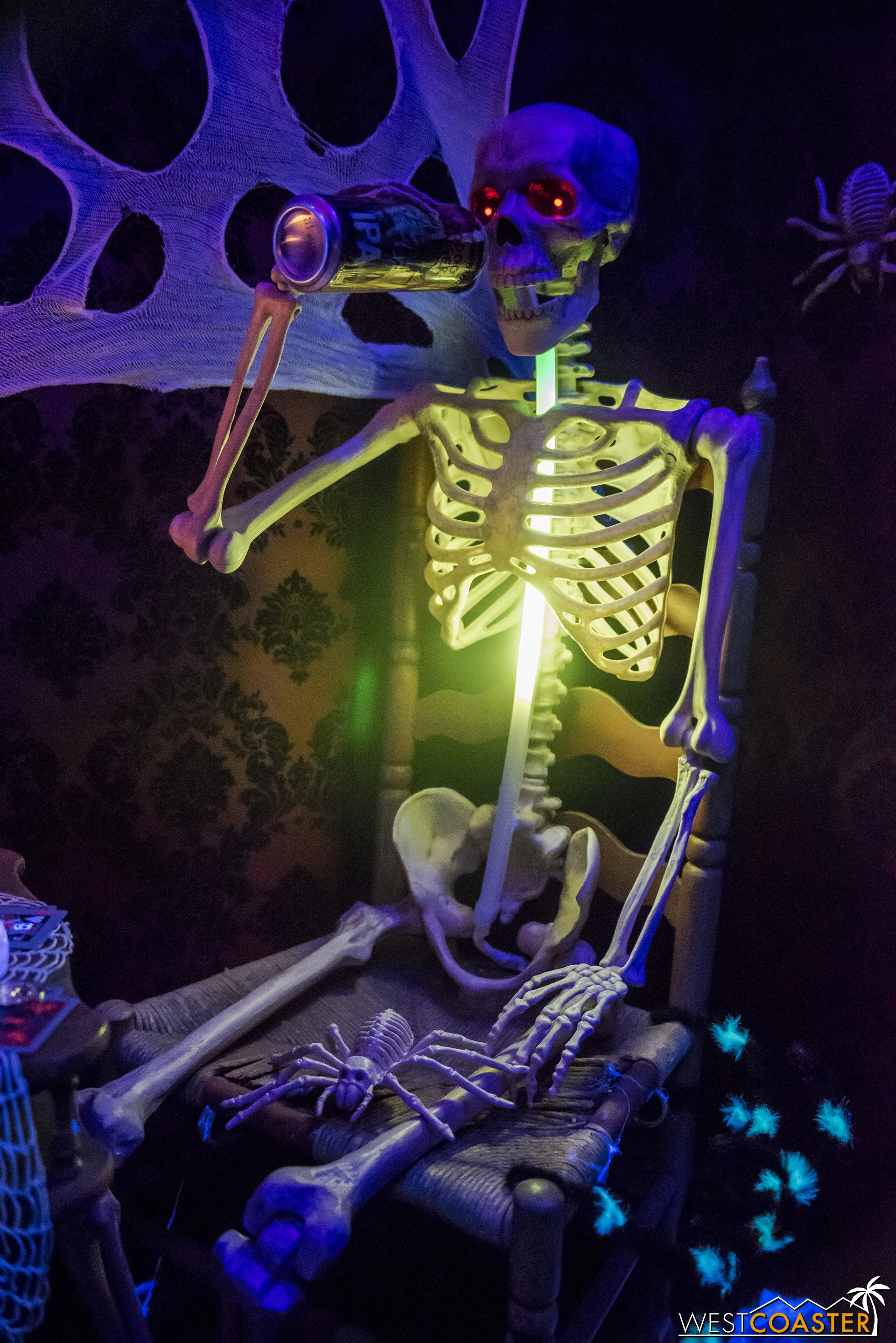 This skeleton drinks some beer that is apparently illuminated as it travels down his not-body.