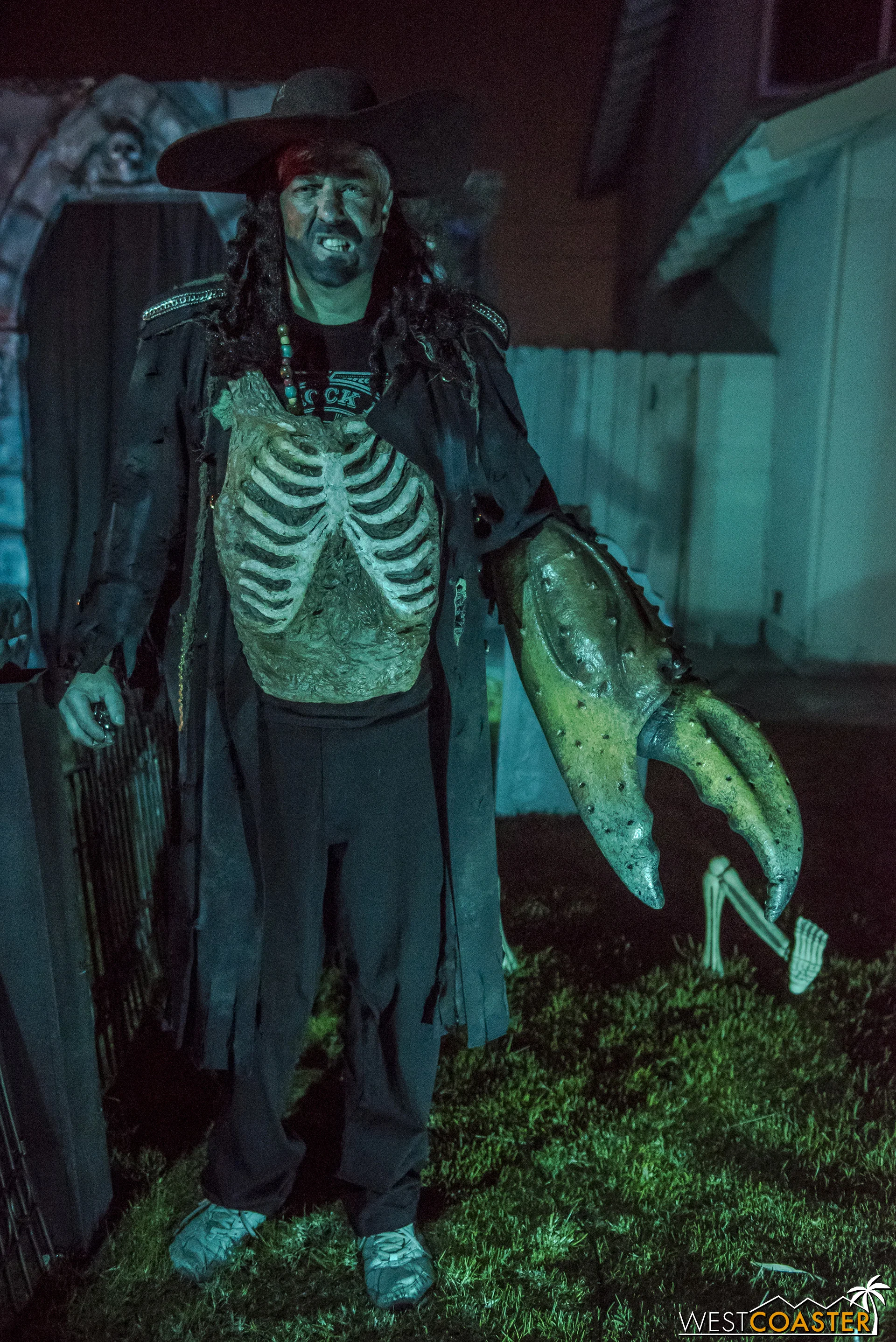Captain Dave poses proudly in front of his creation, which he builds and runs with his family, at The Pirates Cave!