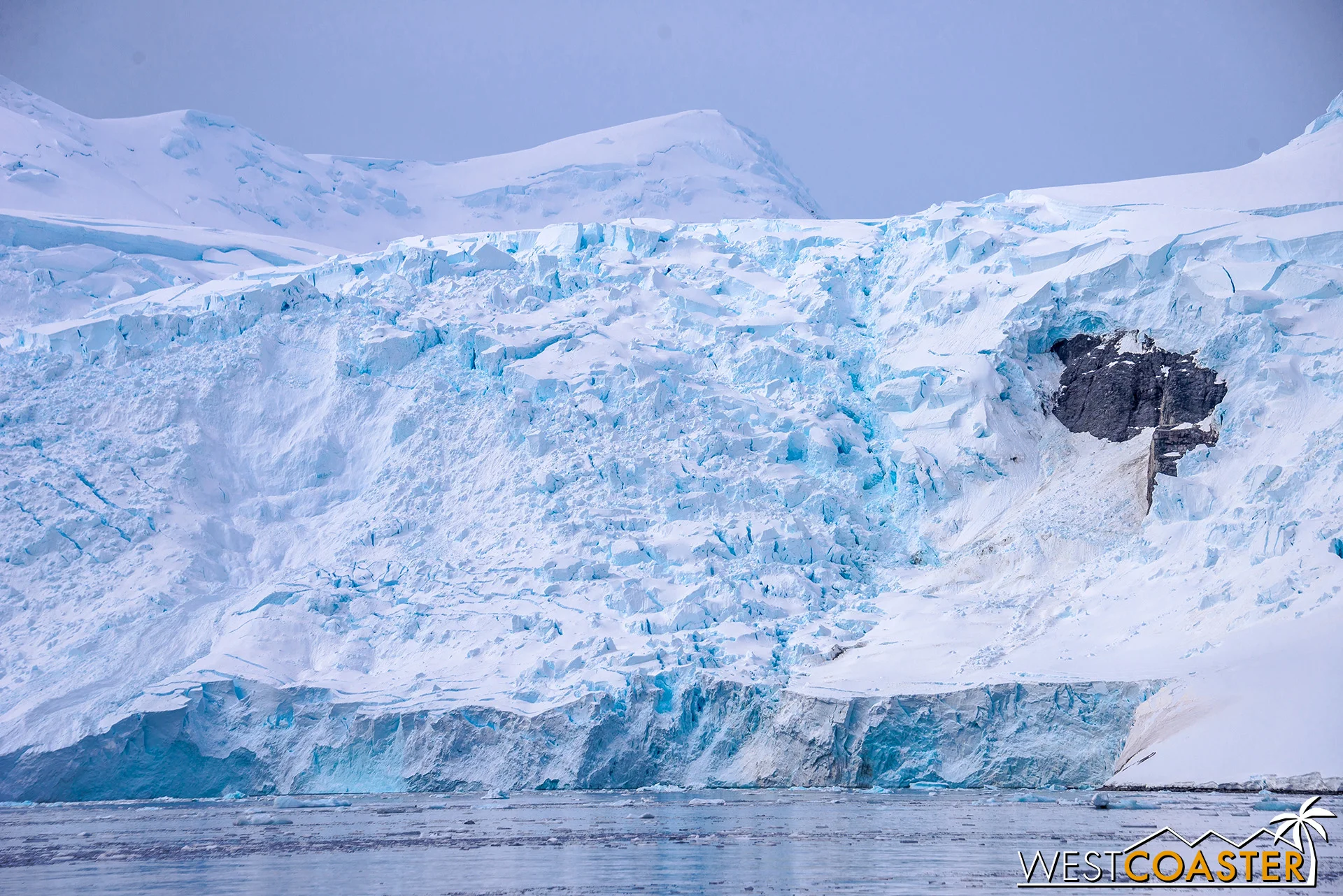 Rippling ice from a nearby snowcap, glaciering into the water.