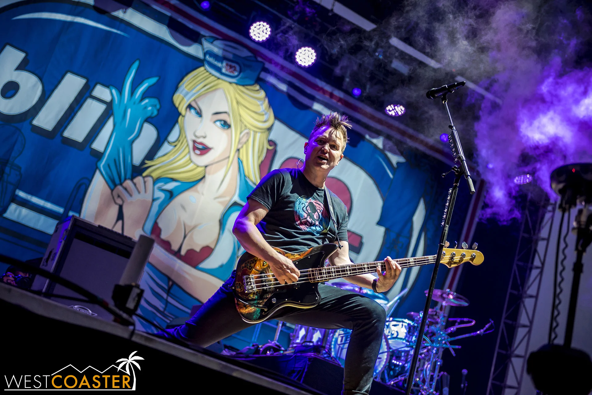 Mark Hoppus striking a power pose on guitar.