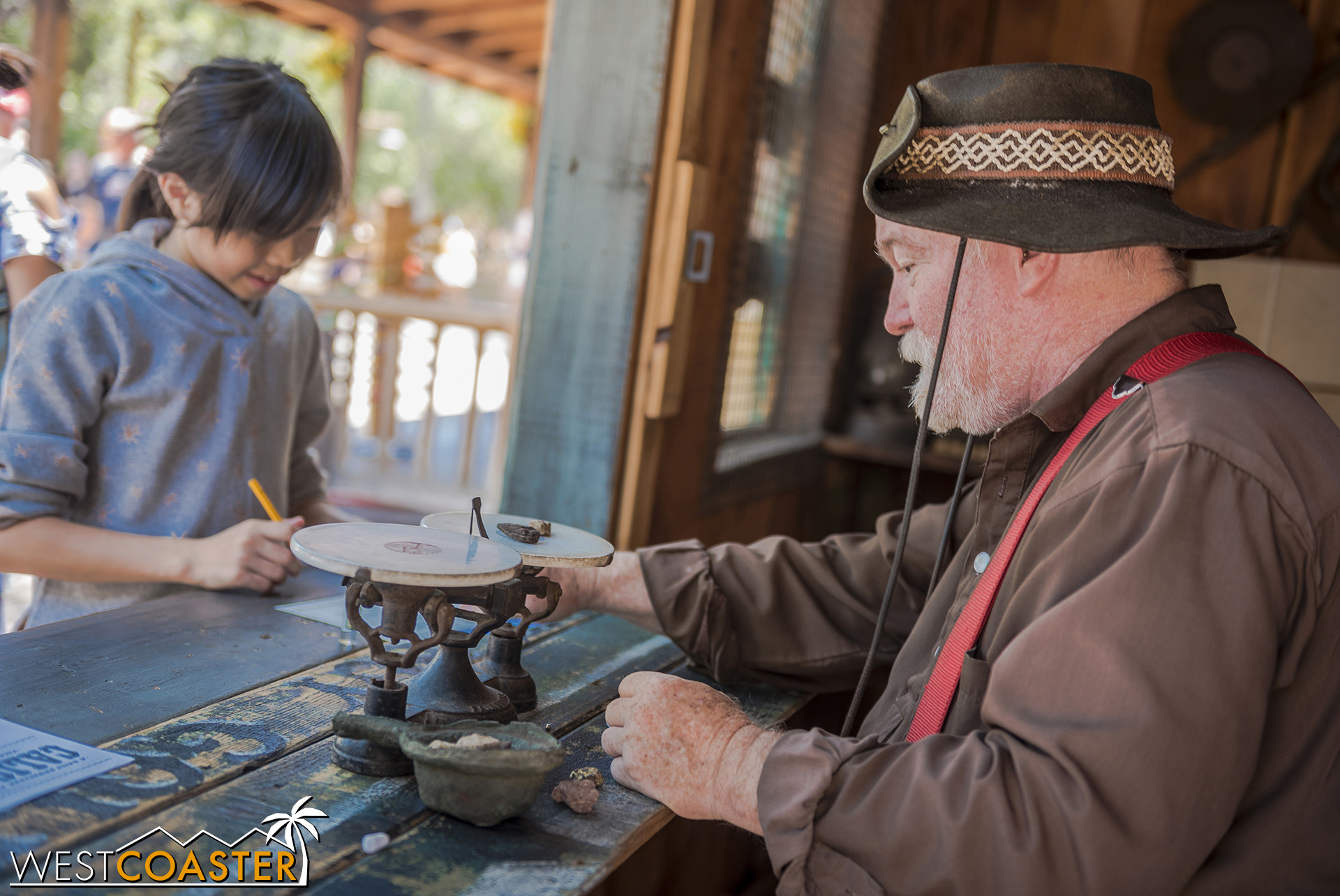  Cannonball weighs a stone from a guest to assess its value. 