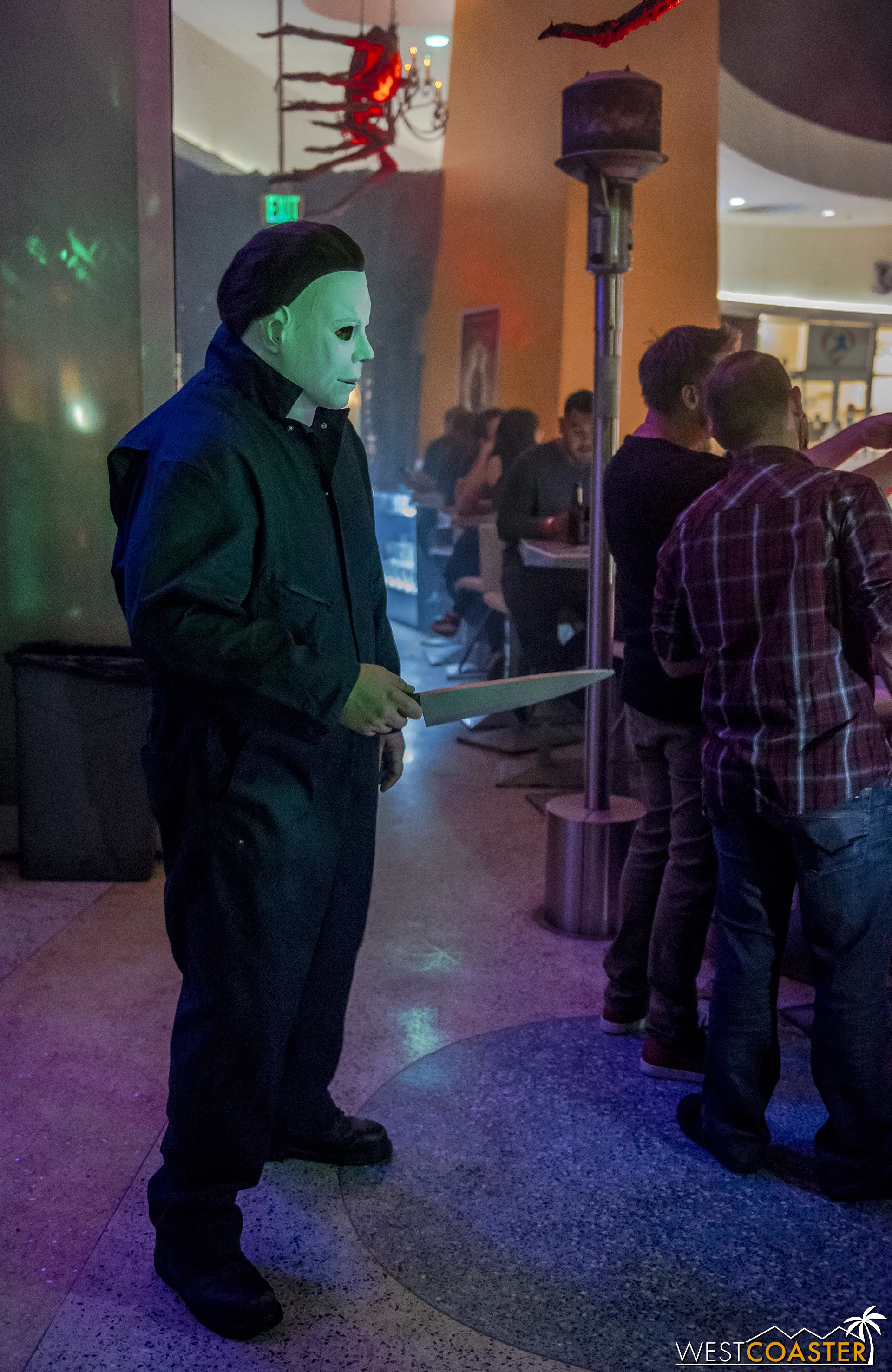 Michael Myers stalks guests but also poses for photos.