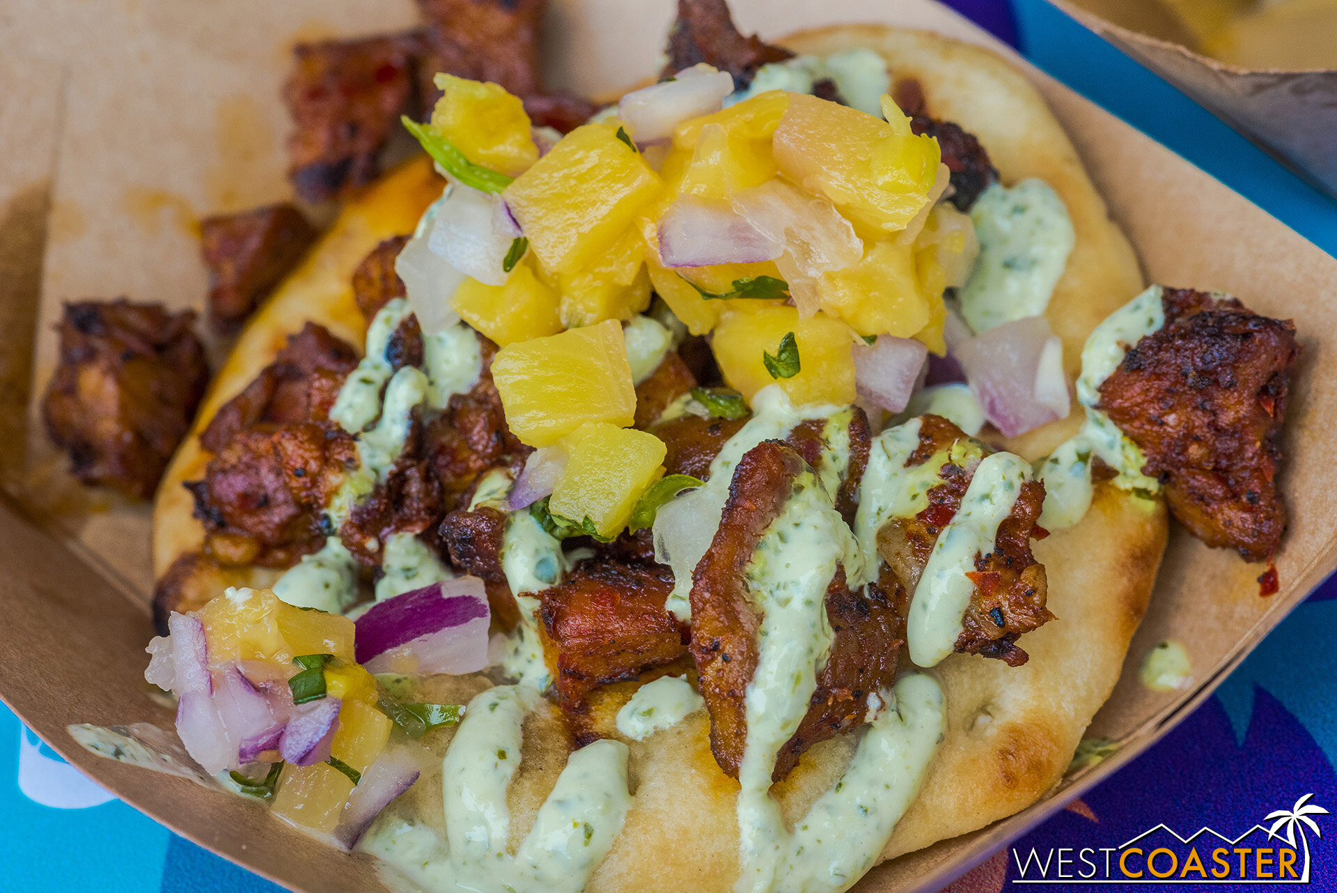  Merry Mashups Marketplace: Pork al Pastor Naan Taco – With Pineapple Pico de Gallo and Cilantro-Lime Crema   There is a lot going on here, but this is a very flavorful and tasty item whose components really work well together.  Although the naan was