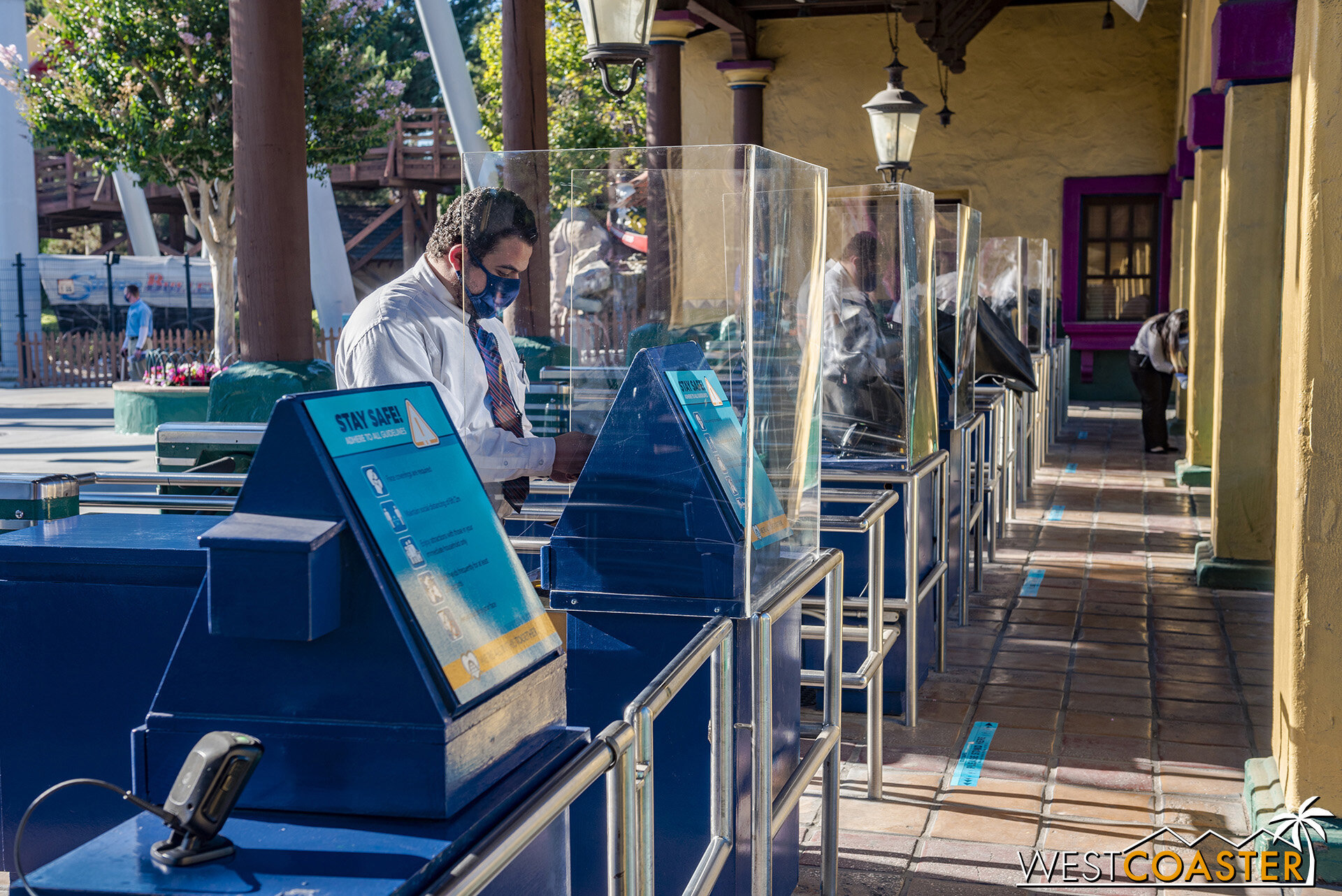  Plexiglass barriers have been installed to keep gate attendants better protected from the multitude of guests they’ll have to engage.  Guests’ reservation ticket barcodes are scanned through the glass, and the attendants set the Tasting Card and lan