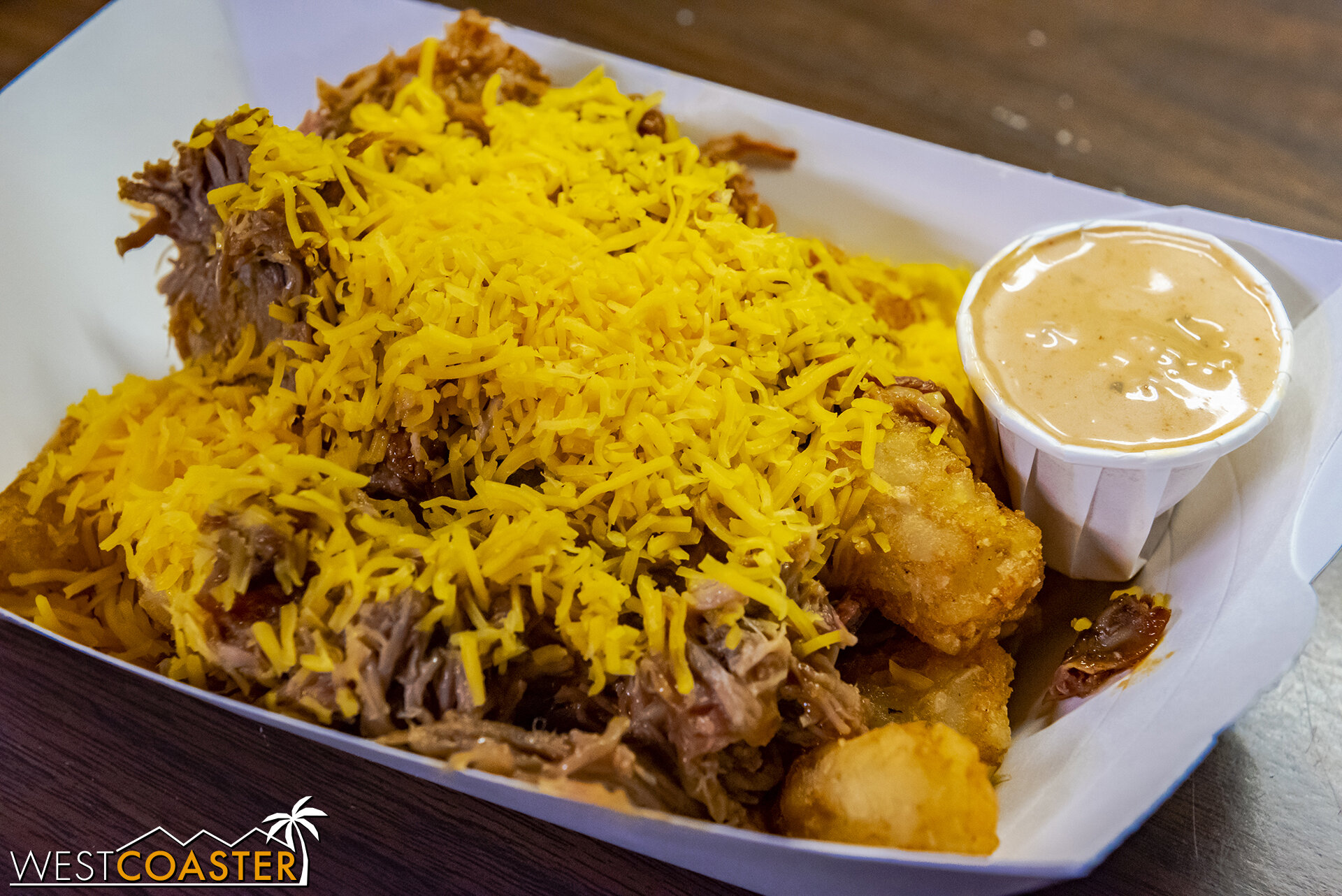  Tater Tots Topped with BBQ Marinated Pulled Pork, Chipotle Ranch, and Shredded Cheddar Cheese, from Sutter’s Grill or Calico Fry Co. 