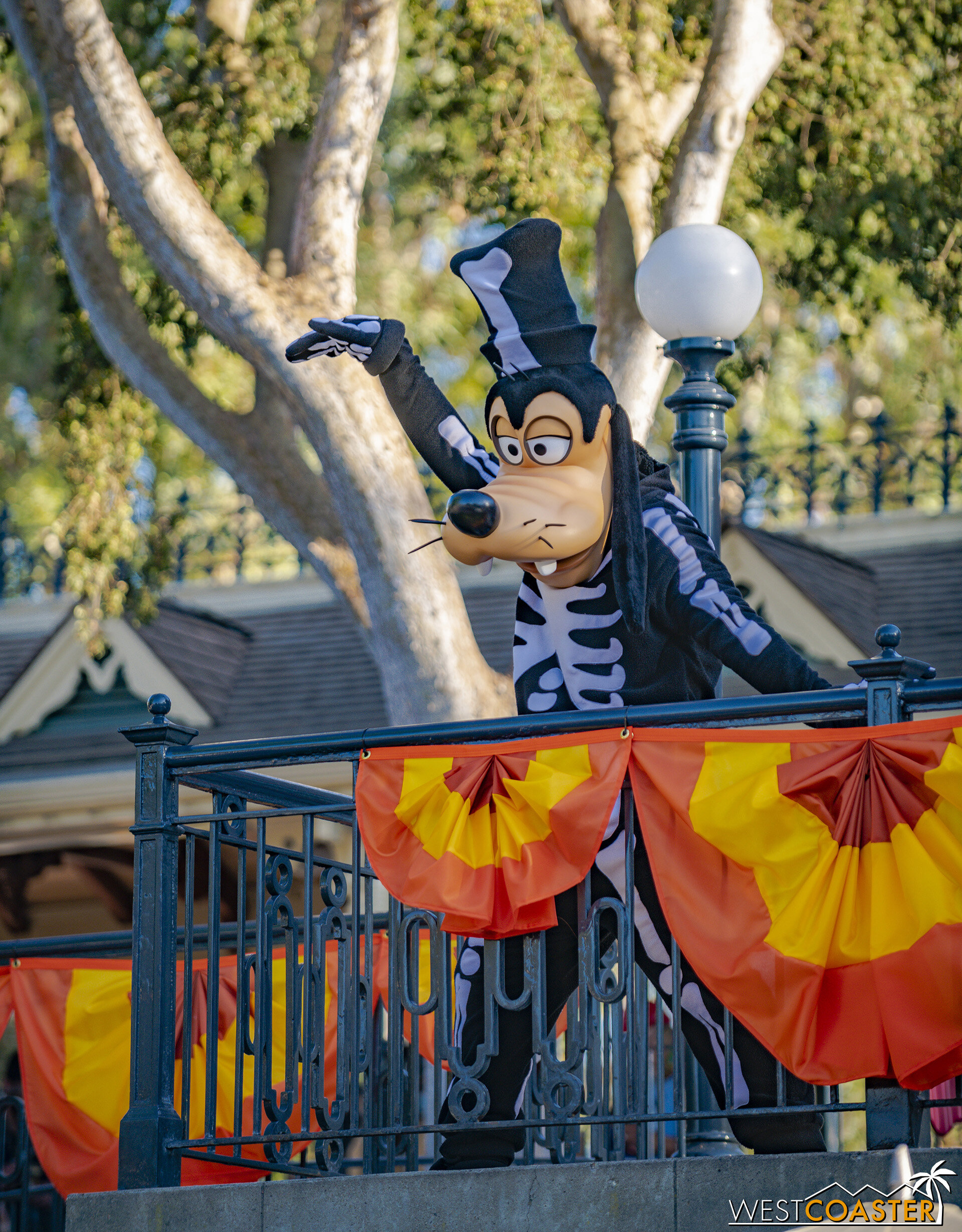  At the Disneyland Railroad Main Street Station, guests can see Disney characters greeting and interacting with fans from afar. 