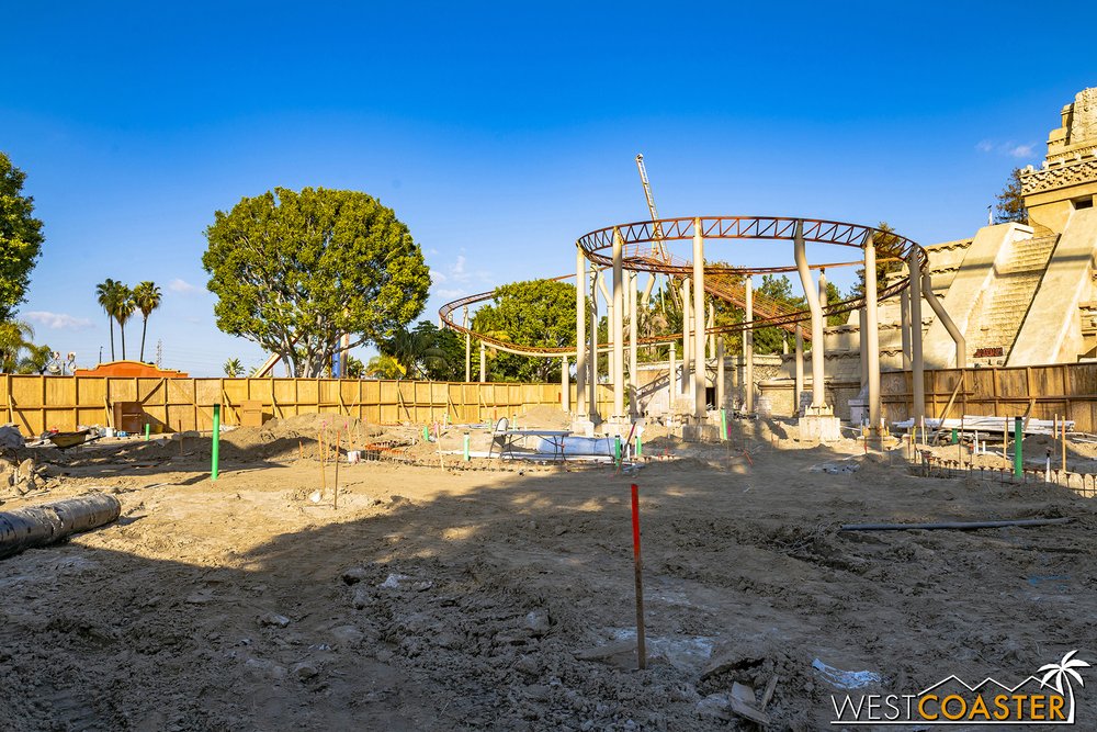  Peaking through the hand-sized openings at select spots along the construction walls, we could see that the arcade games and pavement between the Fiesta Village Stage and Jaguar had been completely removed. 