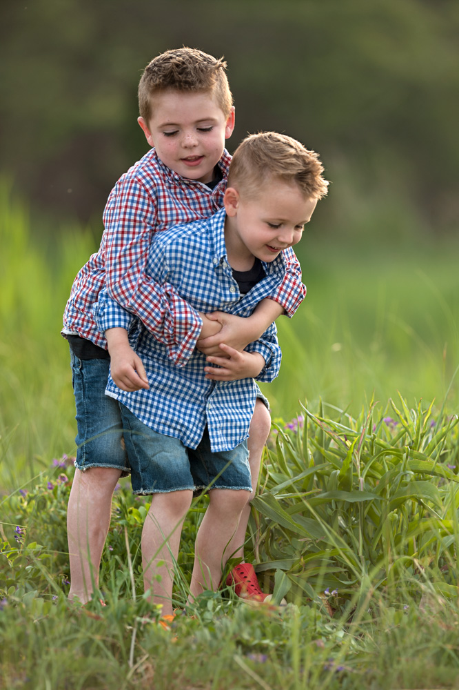 Boys playing around during a family photo session in plymouth ma