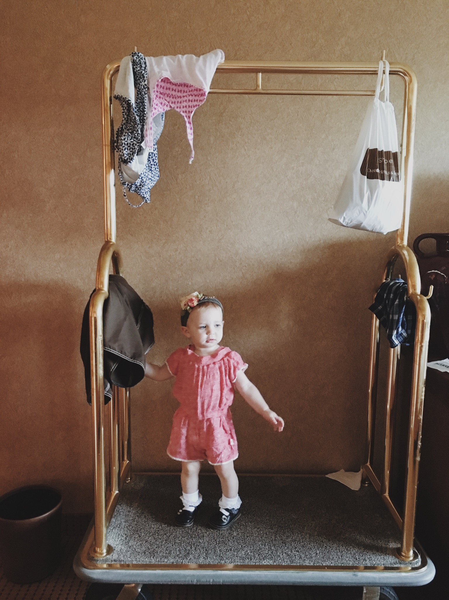 ...and our little stunt baby...taking full advantage of the great play to be had on the luggage cart!