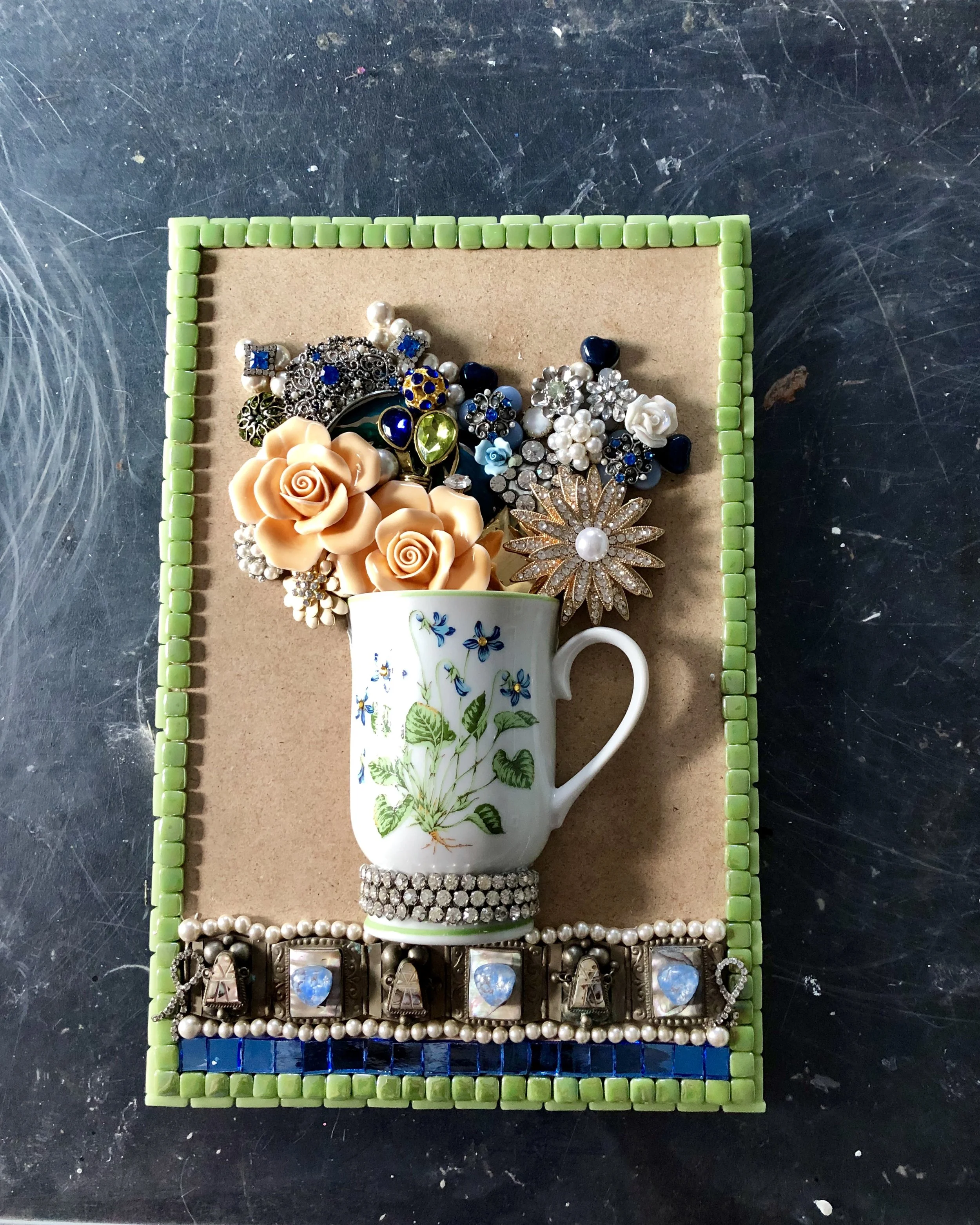 Client’s half cup Duo. Tesserae includes Jewelry given to me by the client(her Mothers’s) and the cup. I was able to get a clean cut on the cup. Therefore, I was able to make two panels. I added further embellishments to complete the design. I really liked how these are turning out.