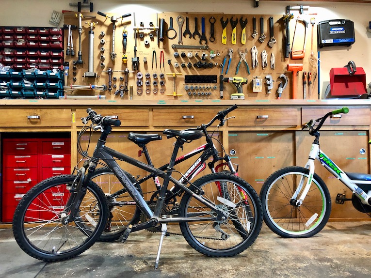 The bikes when they arrived at the bike hospital. Can you spot the flats? Tools at the ready.