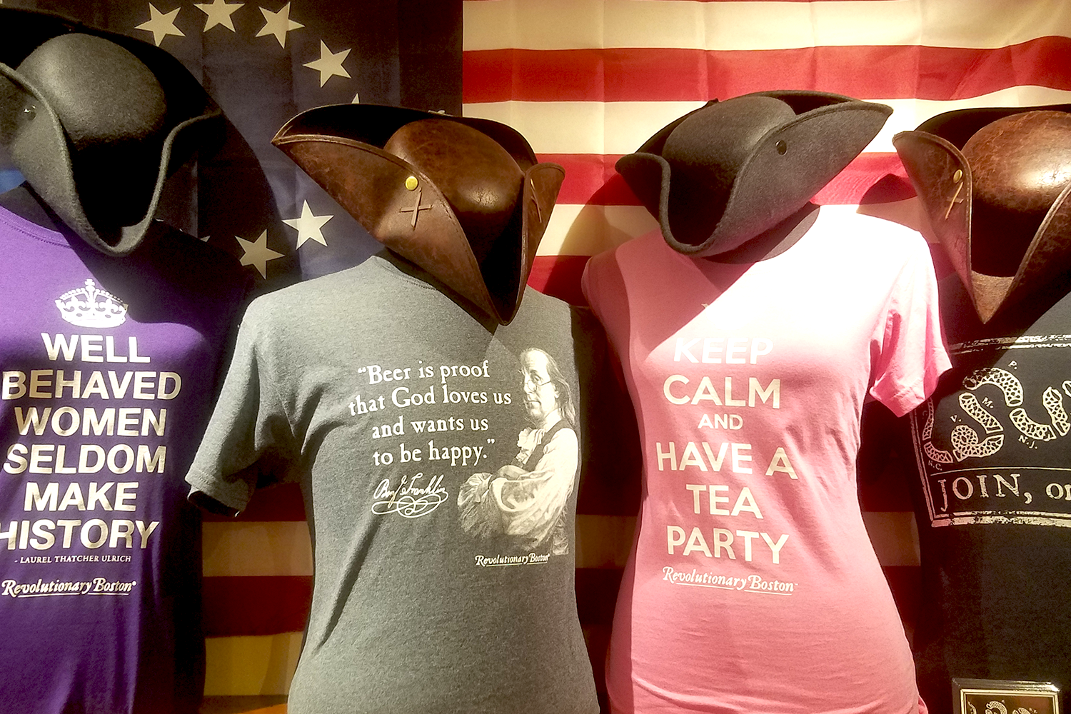 Row of mannequins wearing Revolutionary Boston t-shirts.