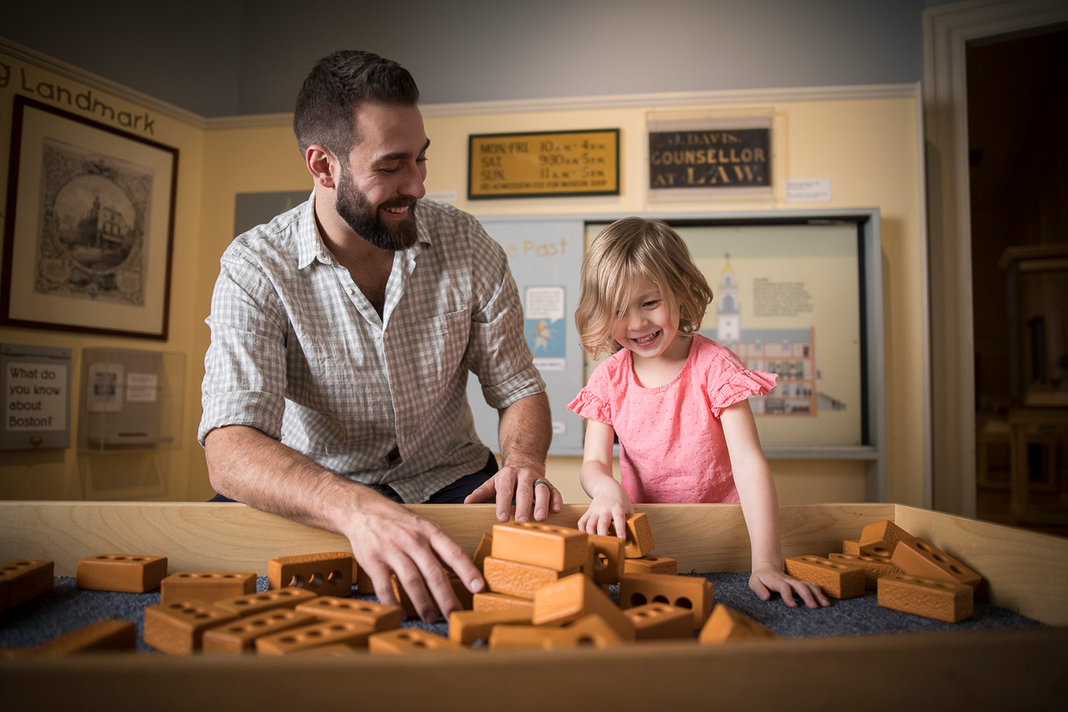 Man and young girl with foam building bricks.
