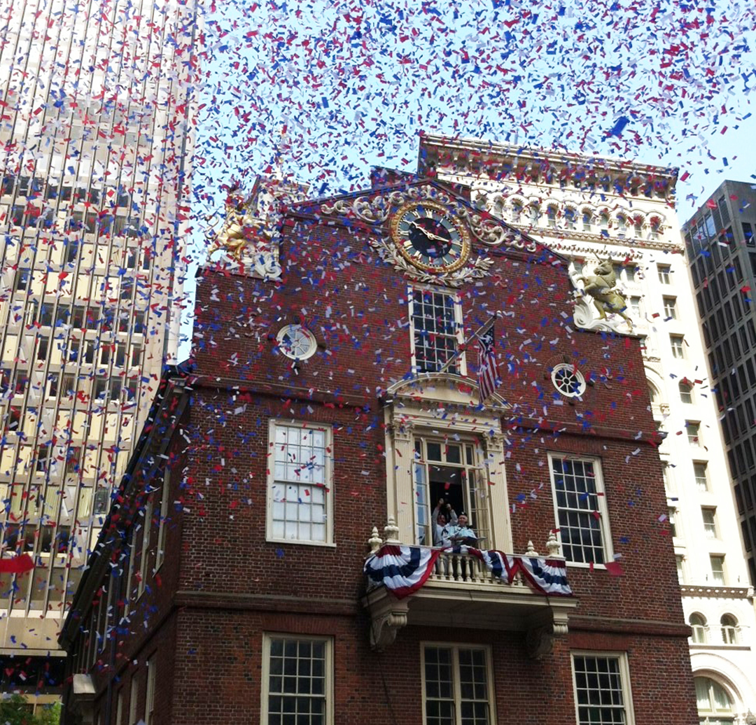 Confetti flying before the Old State House.