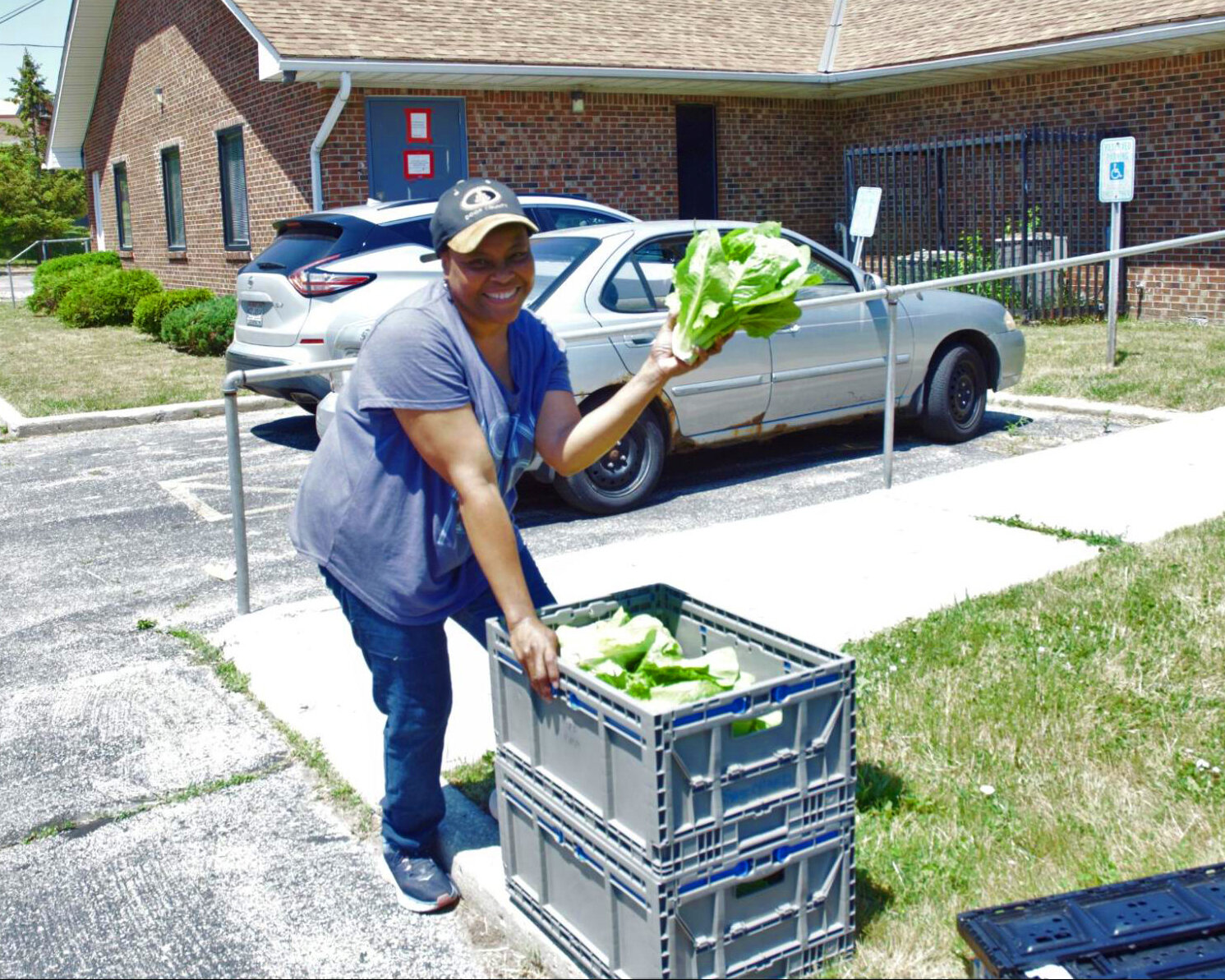 Billie accepting a donation of greens from the Maglio Farm.