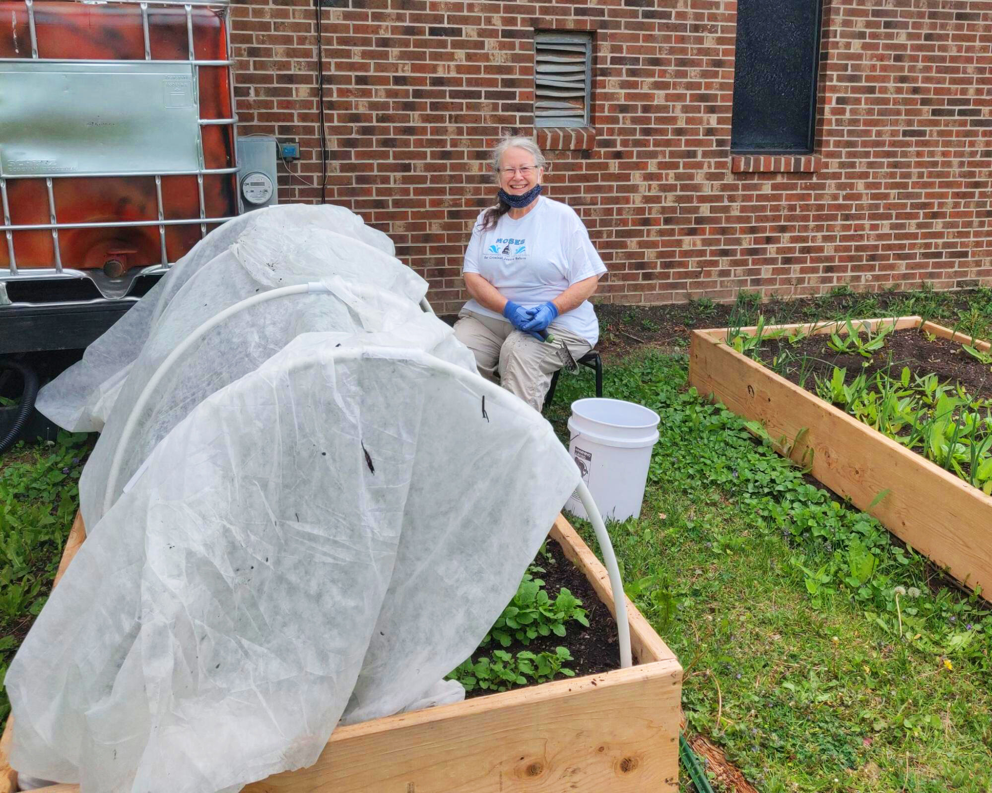  Katharine planting in Solomon Community Temple’s Belong Place garden beds which were recently constructed in partnership with Groundwork Milwaukee. 