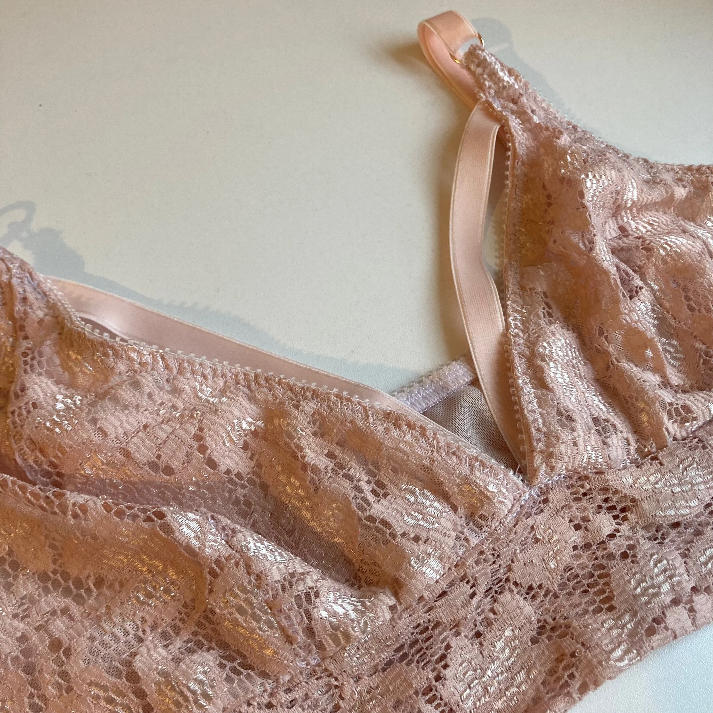 Pink lace bralette close up flat lay