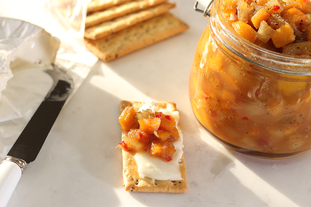 Persimmon chutney on Brie cheese and grain cracker.