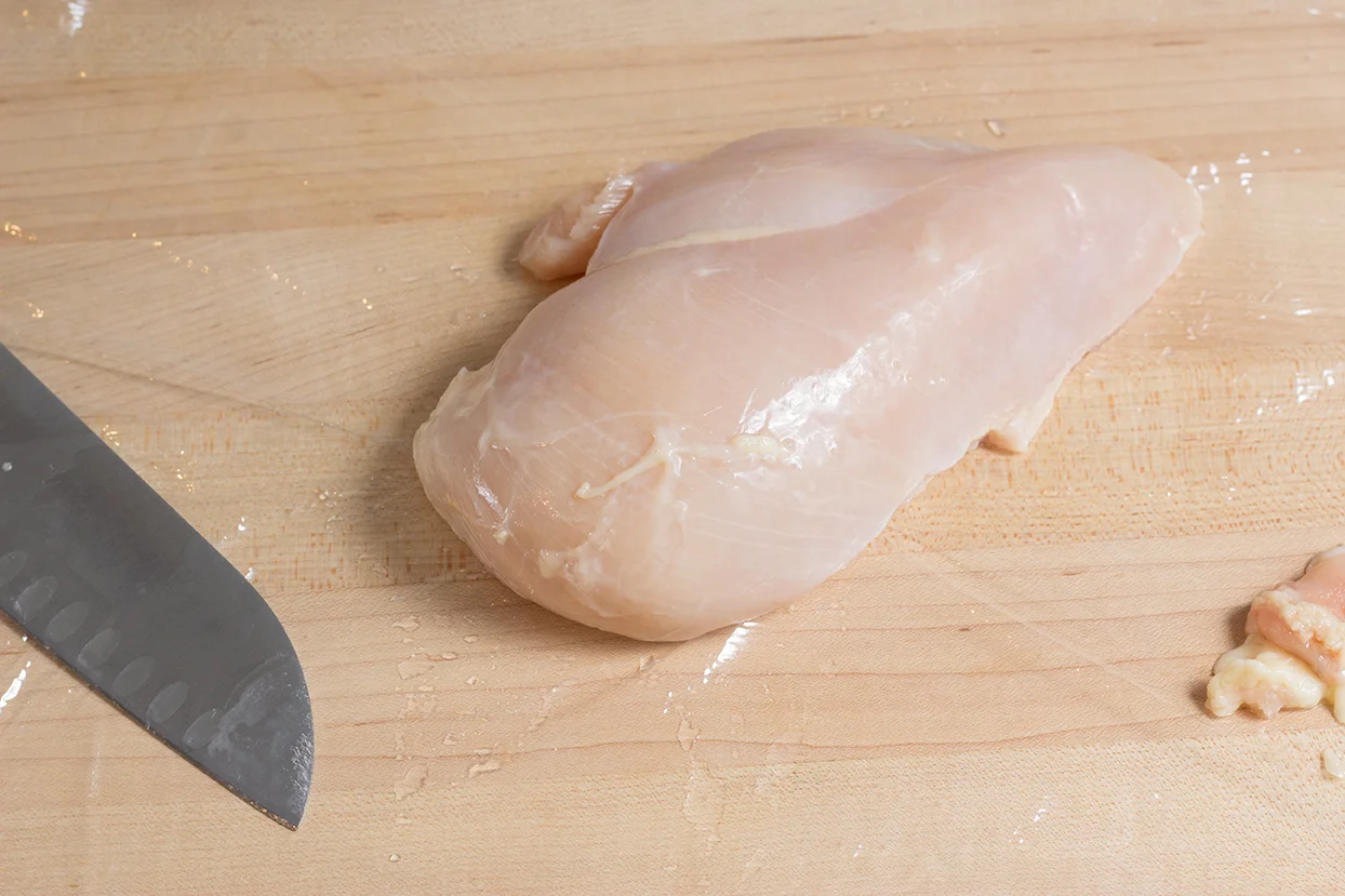 Place chicen breast on top of a cling wrap.