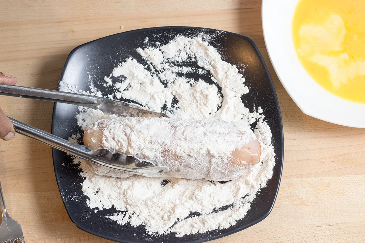 Roll the stuffed breast in the flour. Shake off excess flour.
