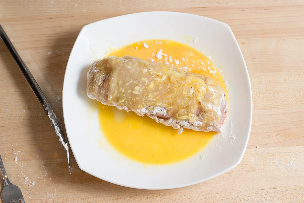 Next, roll the breast in the egg wash.