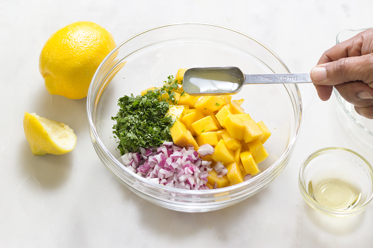 Add lemon juice and zest to chopped mango, cilantro and red onions.