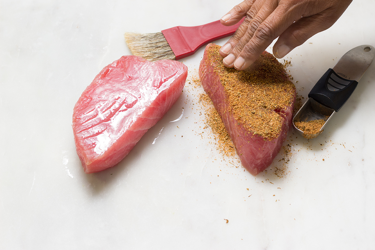 Thoroughly coat top and bottom of tuna steaks with blackened seasoning. Set aside in refrigerator.