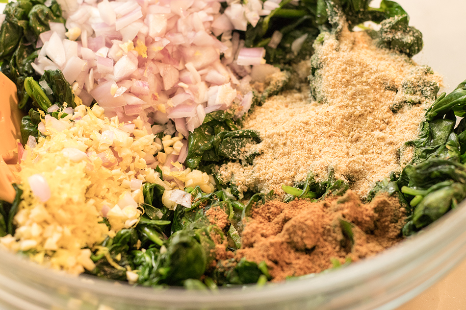 Mix in ingredients to wilted spinach.