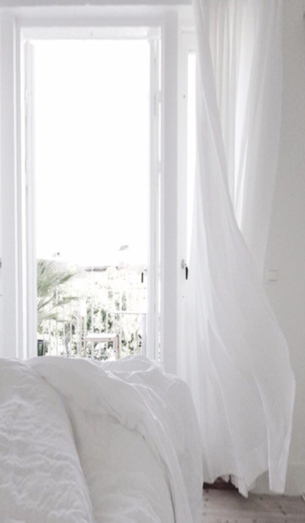 Flowing draperies in dreamy white bedroom source