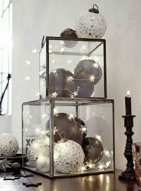 Christmas bulbs and lights in glass boxes image source