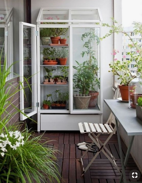 upright free-standing green house on balcony source