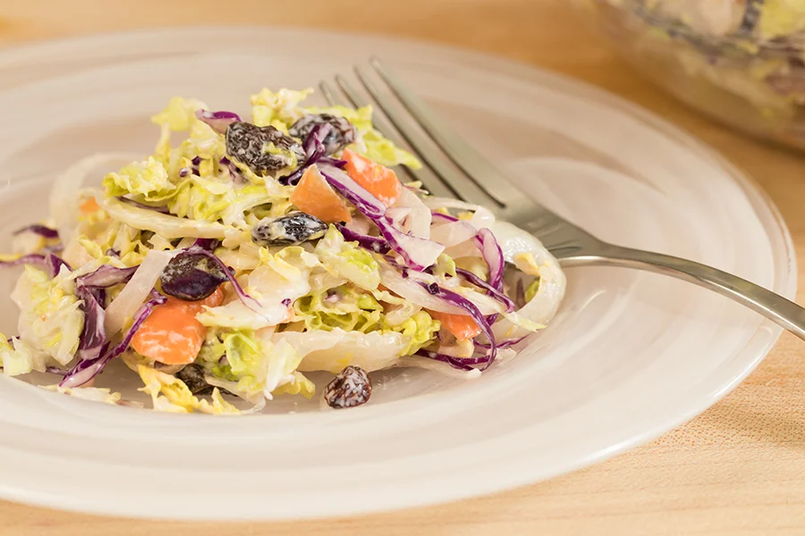 coleslaw and raisins and cream cheese and mayonnaise dressing