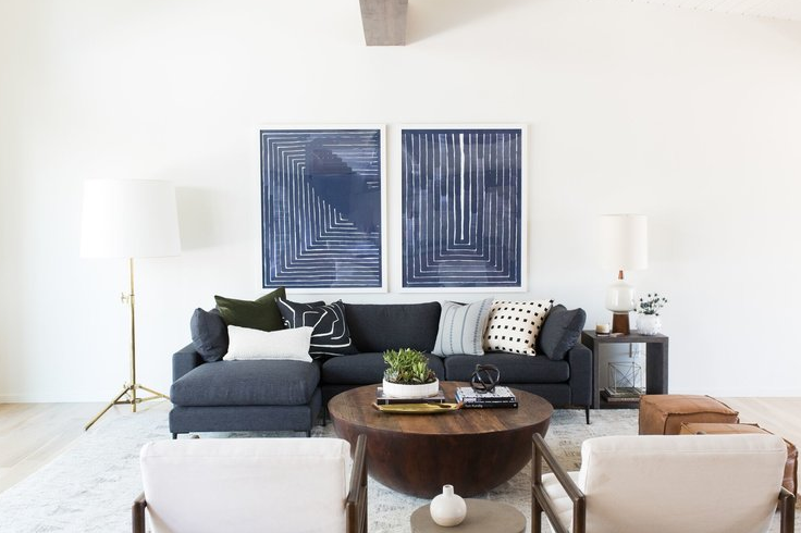 White wall, medium blue sofa and and blue pictures source Studio McGe e