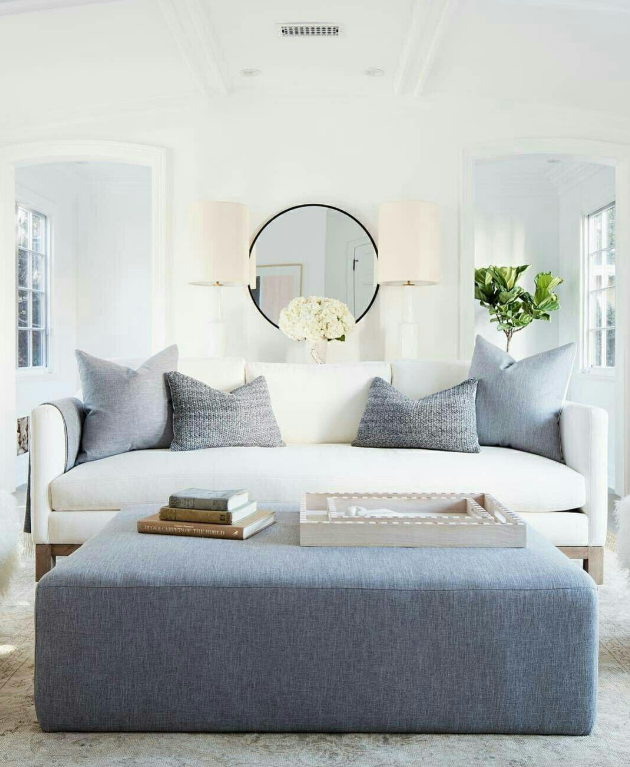 White walls, white sofa, and blue accents source