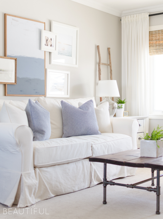 White walls, white sofa and light blue accents source: A Burst of Beautiful