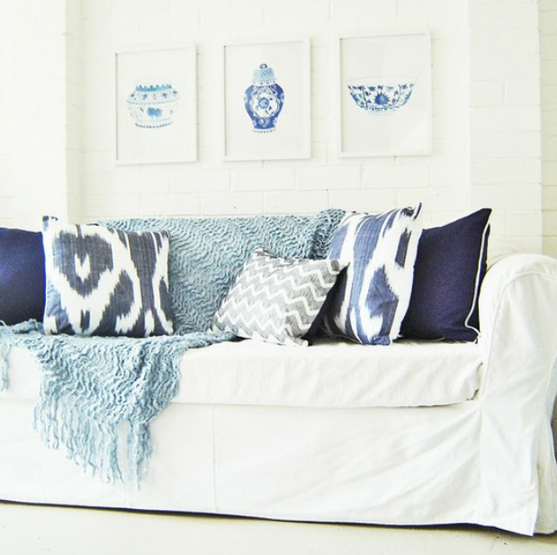 White slipcovered sofa with blue accents source