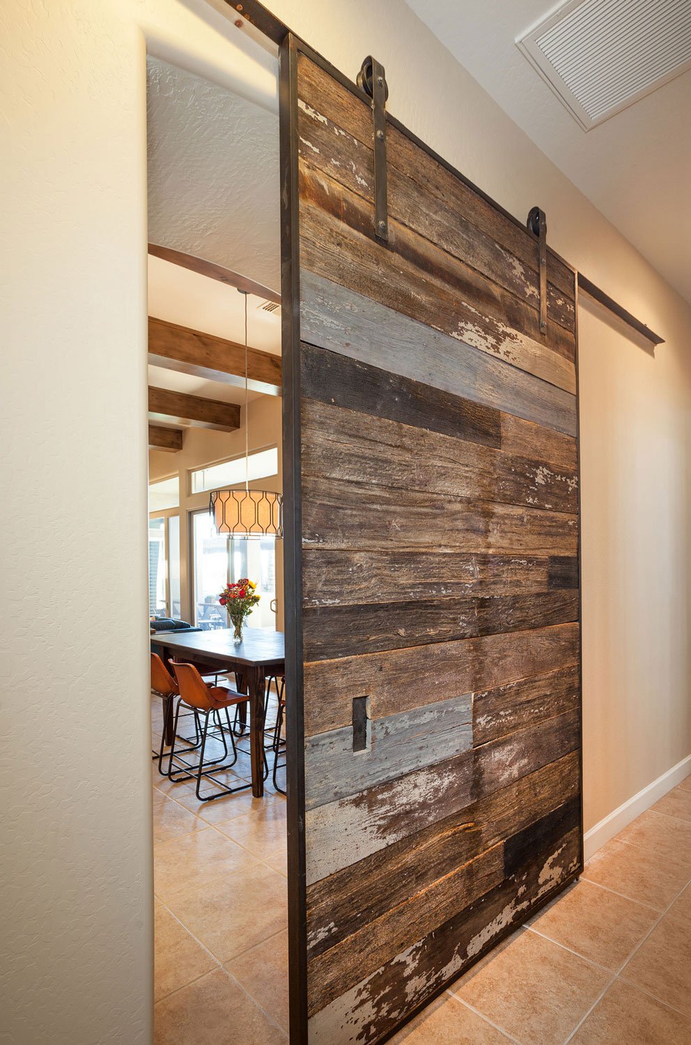 A custom barn wood door makes a statement in this rustic home. Image: James Stewart