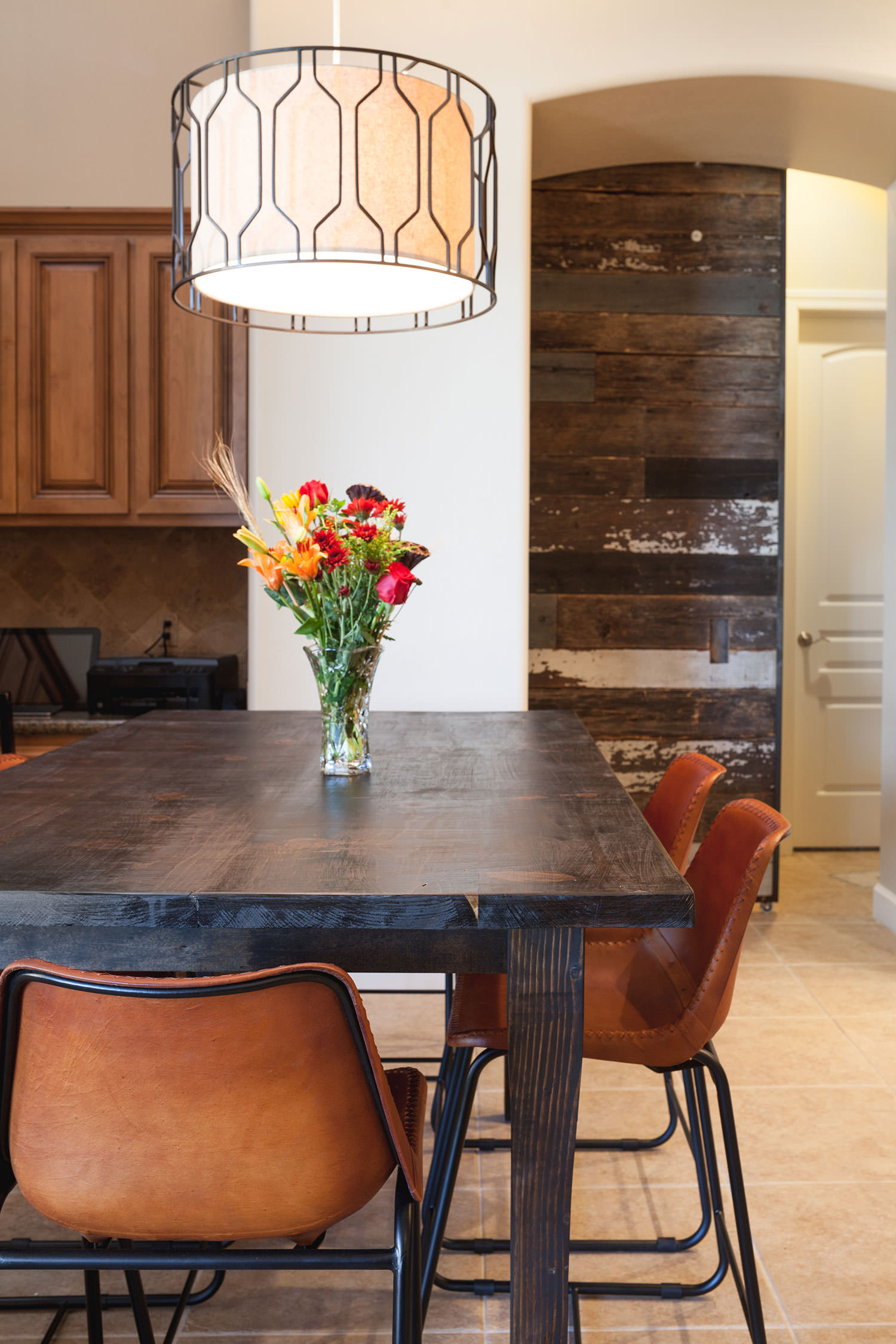 Saddle leather chairs paired with a rustic wood table create the perfect southwest inspired dining room. Image: James Stewart