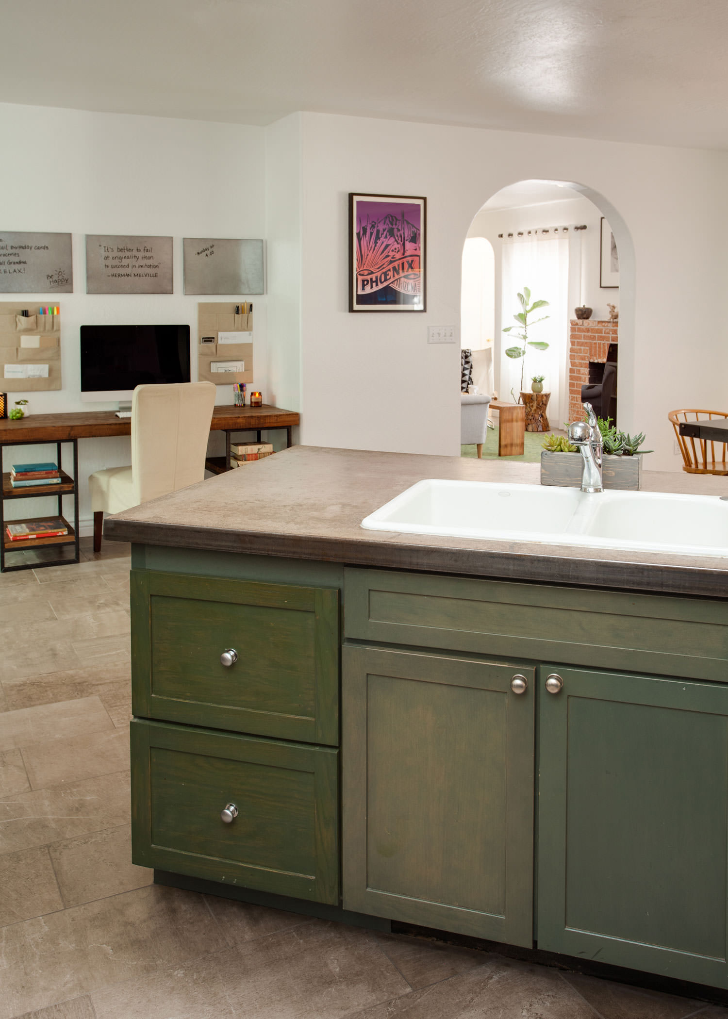The dark green hue of the kitchen cabinets ground the space while creating an inviting atmosphere. Image: James Stewart