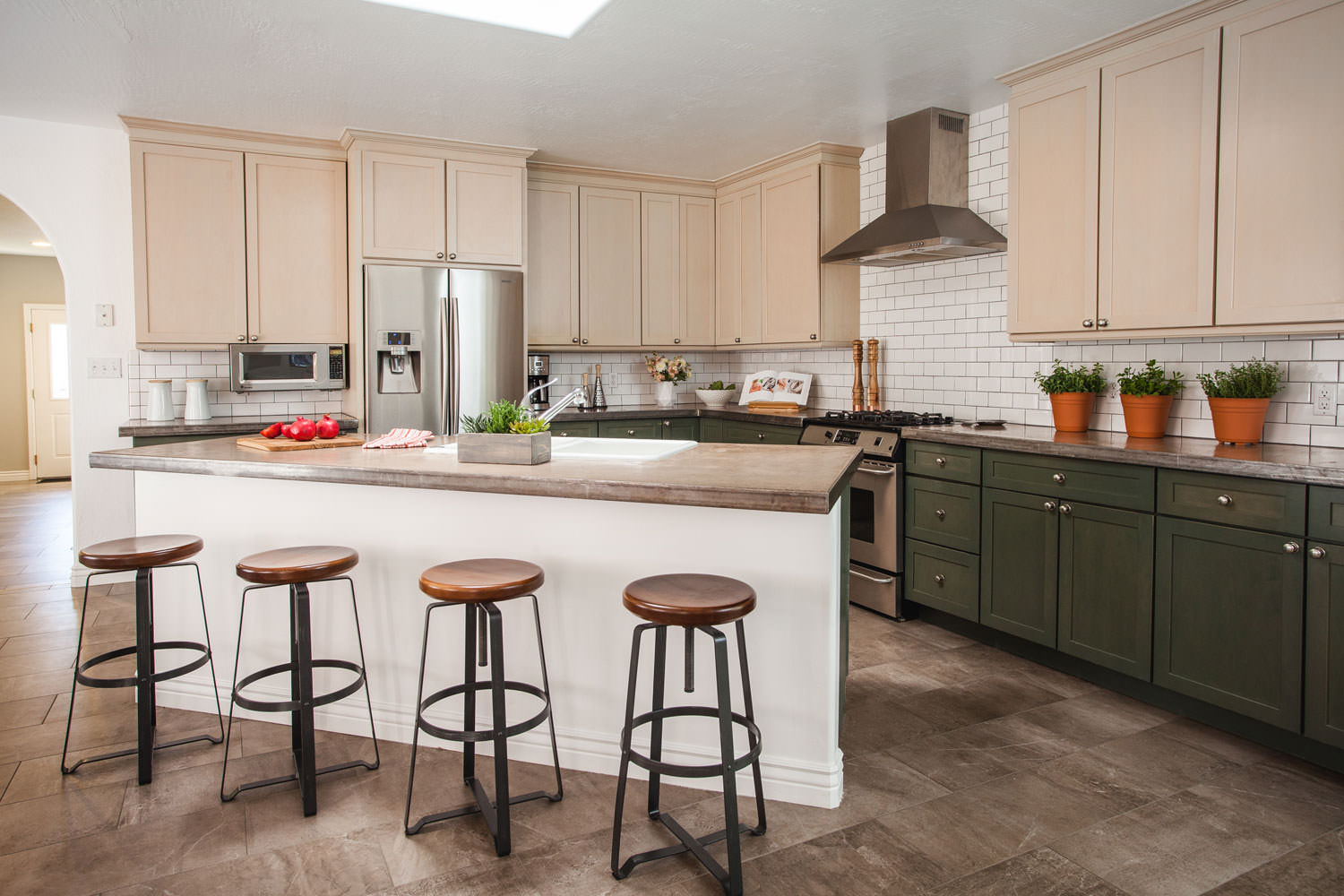 Balance lighter tones on top of dark hues keeps the kitchen feeling bright and open.