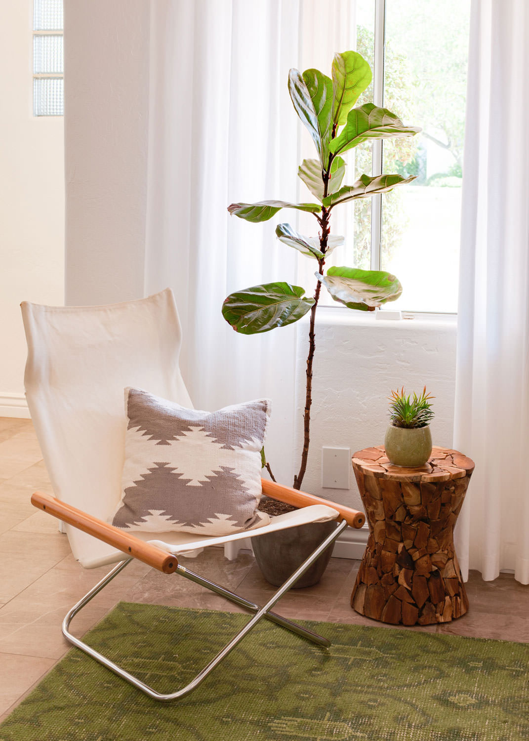 The warm wood texture of the side table and moss green hue in the rug creates a relaxed bohemian atmosphere. Image: James Stewart