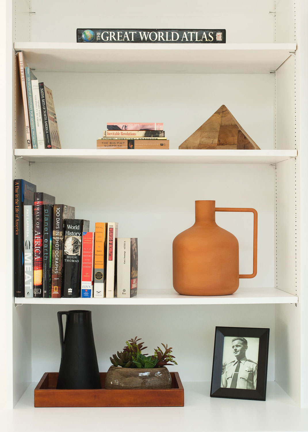 Decorate a shelf with books and accessories from around the world for a cool and collected look. Image: James Stewart