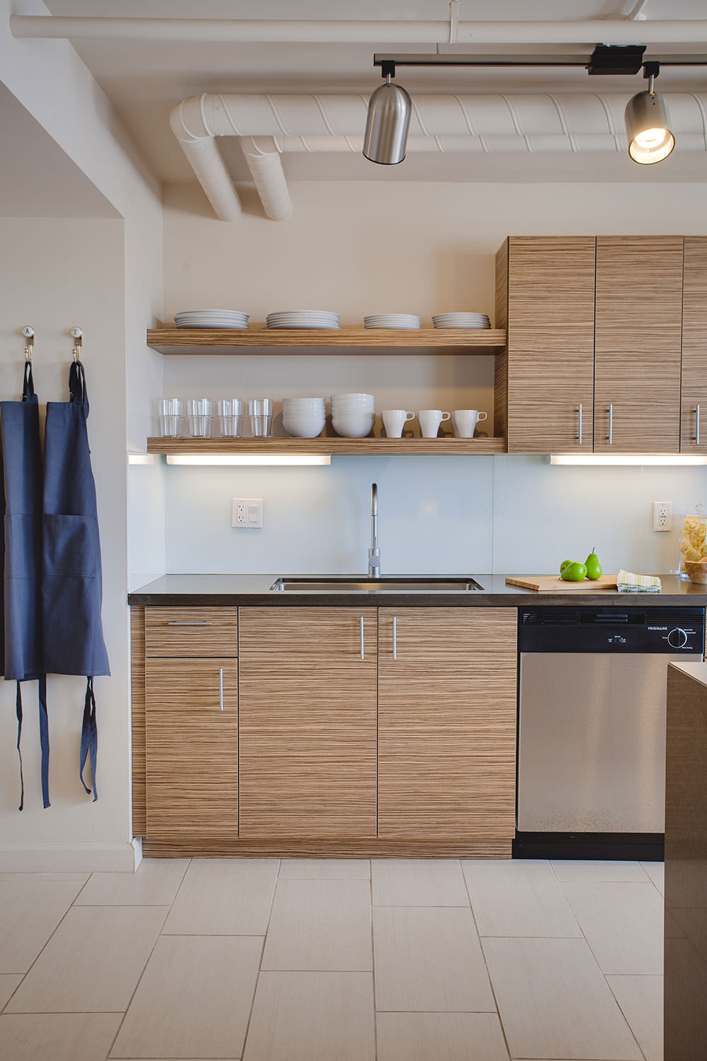 The open shelving in the kitchen allows you to display your very favorite dishware or a collection of plants. With this modern kitchen you can add your own personality to various areas of this Phoenix loft.