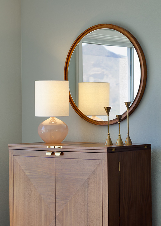 Mid-century silhouettes are the star of this console. We love the vintage brass candle holders!