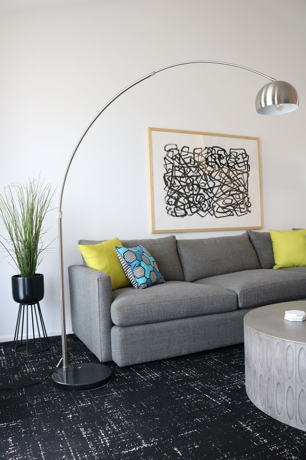An overarching floor lamp is a fantastic decor piece to add dimension and light up a room. Image: Monica Milewski