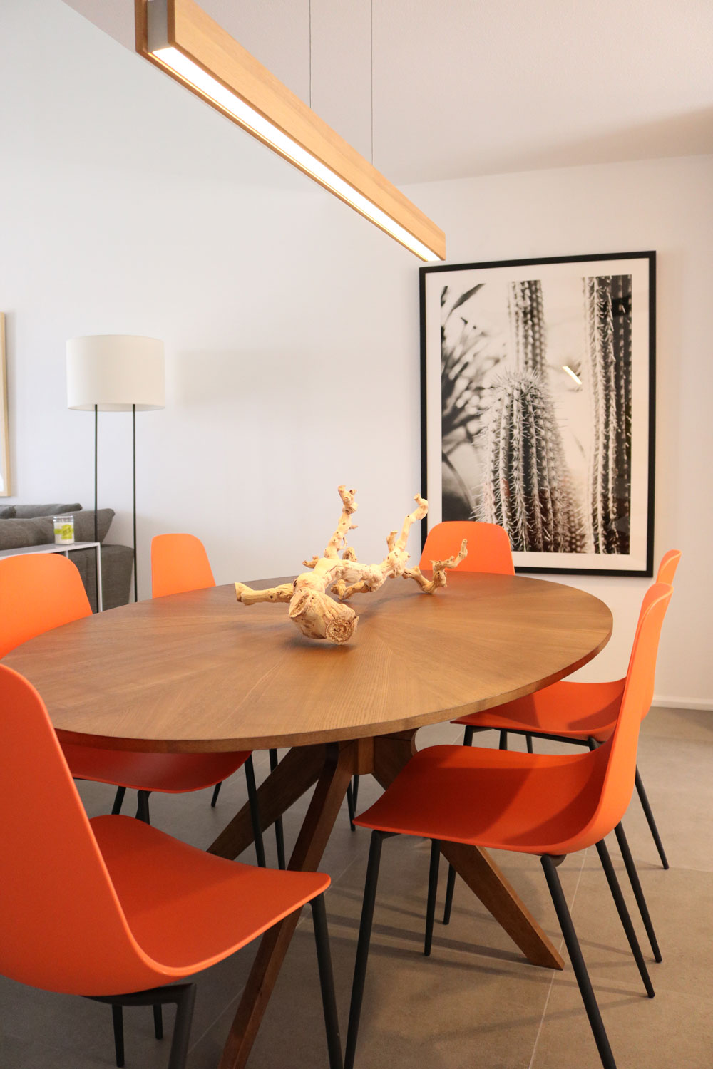 This round mid century inspired dining table defines the open area between the kitchen and living room with its unique shape, creating an easy flow to move around the space. Image: Monica Milewski