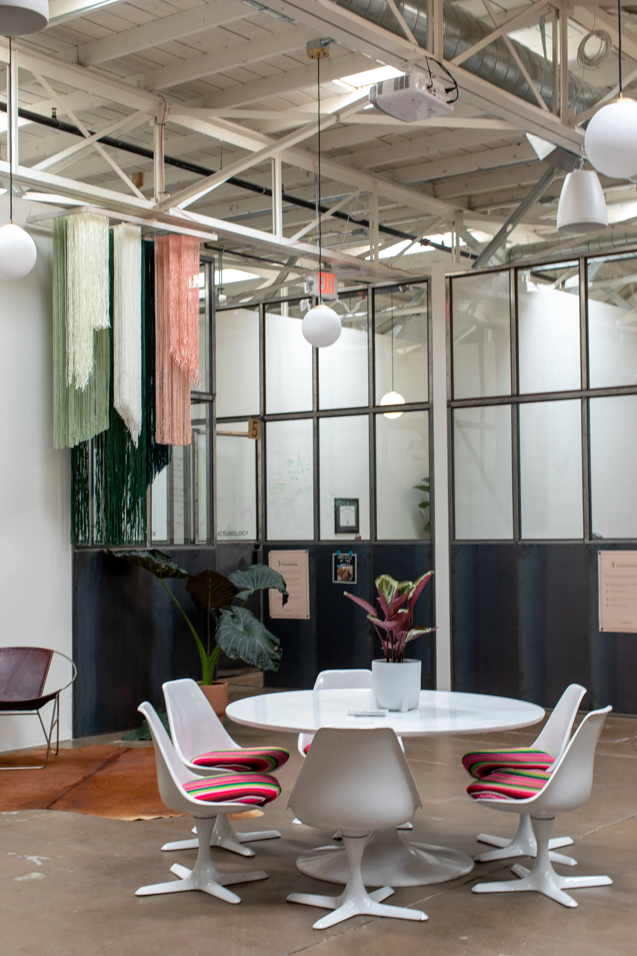 Gather around this classic mid-century table to have a quick chat or a team lunch. Commercial office remodels CAN be bright and inspiring! Jill Richards Photography